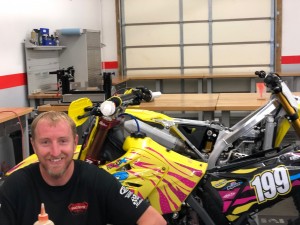 Instructor Scott Adkins working on the 2003 Suzuki RM125